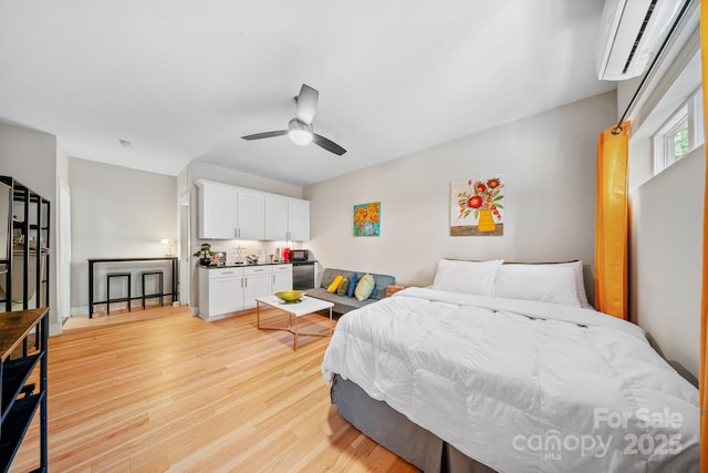 1115 Greenleaf Ave Unit B, Charlotte, NC 28202 - bedroom featuring light wood-style flooring, ceiling fan, and a wall unit AC