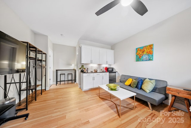 1115 Greenleaf Ave Unit B, Charlotte, NC 28202 - living room with ceiling fan, baseboards, and light wood-style floors