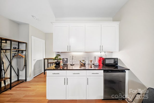 1115 Greenleaf Ave Unit B, Charlotte, NC 28202 - kitchen featuring light wood-style floors, dark countertops, white cabinets, and black microwave