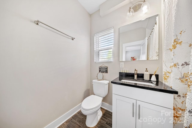1115 Greenleaf Ave Unit B, Charlotte, NC 28202 - bathroom featuring toilet, baseboards, wood finished floors, and vanity