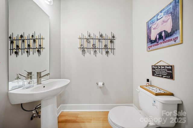 1115 Greenleaf Ave Unit B, Charlotte, NC 28202 - bathroom with baseboards, toilet, and wood finished floors