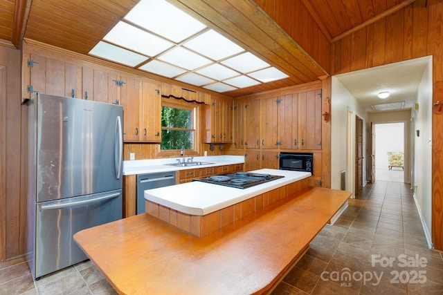 567 Willie Ln, York, SC 29745 - kitchen featuring light countertops, wooden walls, wooden ceiling, a sink, and black appliances