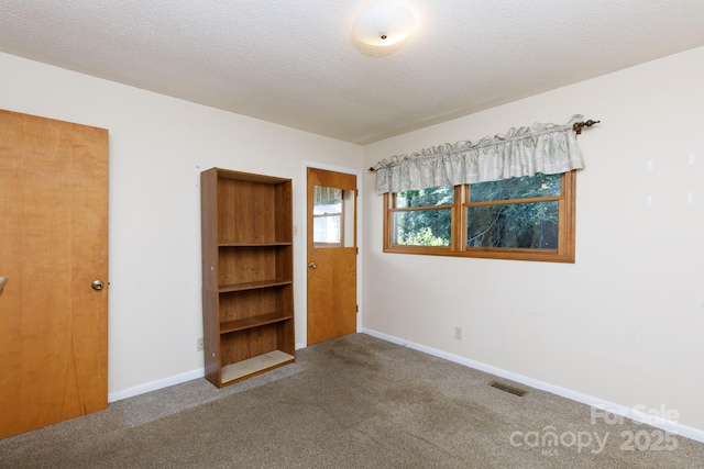 567 Willie Ln, York, SC 29745 - carpeted empty room featuring baseboards, a textured ceiling, and visible vents