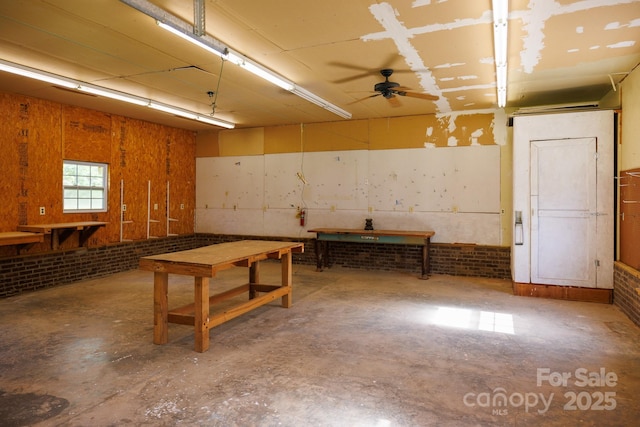 567 Willie Ln, York, SC 29745 - basement featuring brick wall, a ceiling fan, and a workshop area