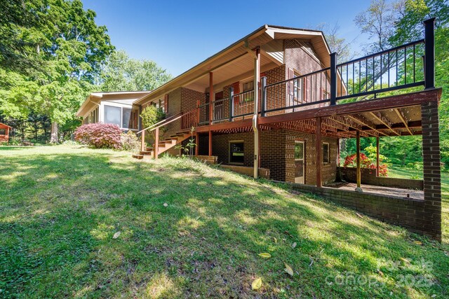 567 Willie Ln, York, SC 29745 - rear view of house with brick siding, a lawn, a wooden deck, and stairs