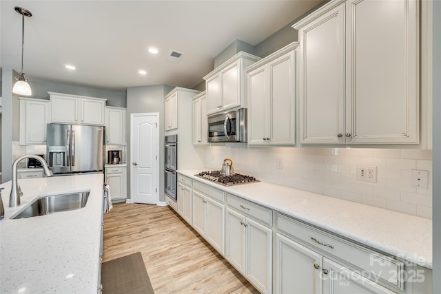 4083 Home Grown Way, Clover, SC 29710 - kitchen with decorative backsplash, visible vents, a sink, and appliances with stainless steel finishes