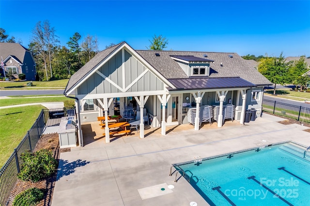 4083 Home Grown Way, Clover, SC 29710 - back of property with roof with shingles, a fenced backyard, a community pool, board and batten siding, and a patio
