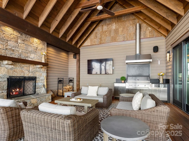 61 Back Bone Way Unit 203, Sylva, NC 28779 - living room with high vaulted ceiling, beam ceiling, wooden walls, an outdoor stone fireplace, and hardwood / wood-style flooring