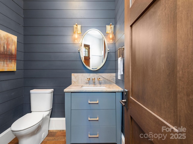 61 Back Bone Way Unit 203, Sylva, NC 28779 - half bathroom featuring toilet, wood finished floors, vanity, wooden walls, and baseboards