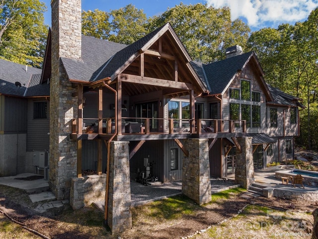 61 Back Bone Way Unit 203, Sylva, NC 28779 - rear view of house featuring an attached garage, a patio area, a shingled roof, and a chimney