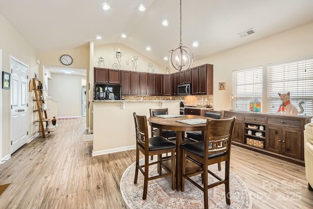 3939 Archer Notch Ln, Huntersville, NC 28078 - dining area featuring a chandelier, vaulted ceiling, light wood-type flooring, recessed lighting, and baseboards