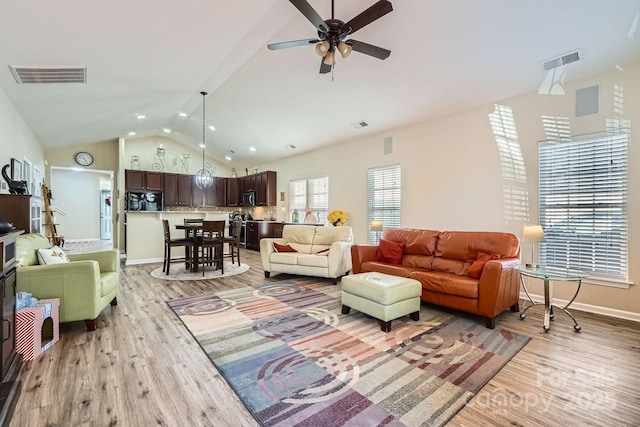 3939 Archer Notch Ln, Huntersville, NC 28078 - living area featuring vaulted ceiling, light wood-style floors, a ceiling fan, and baseboards