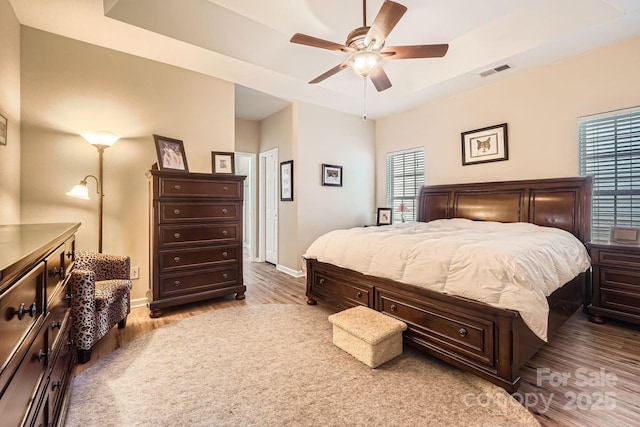 3939 Archer Notch Ln, Huntersville, NC 28078 - bedroom with light wood-style floors, baseboards, a raised ceiling, and a ceiling fan