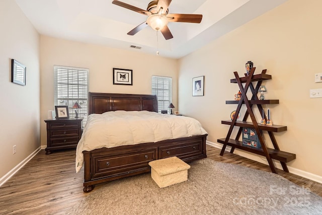 3939 Archer Notch Ln, Huntersville, NC 28078 - bedroom featuring wood finished floors, baseboards, a tray ceiling, and a ceiling fan
