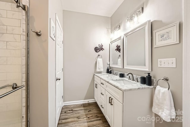 3939 Archer Notch Ln, Huntersville, NC 28078 - bathroom with double vanity, wood finished floors, a tile shower, and baseboards