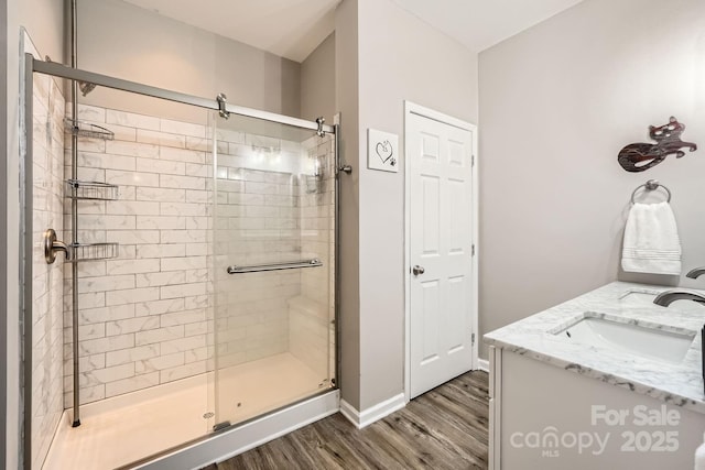 3939 Archer Notch Ln, Huntersville, NC 28078 - bathroom with wood finished floors, a shower stall, vanity, and baseboards