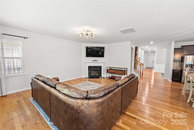 2333 Talon Point Cir, Fort Mill, SC 29715 - living room with light wood-style floors, a glass covered fireplace, and baseboards