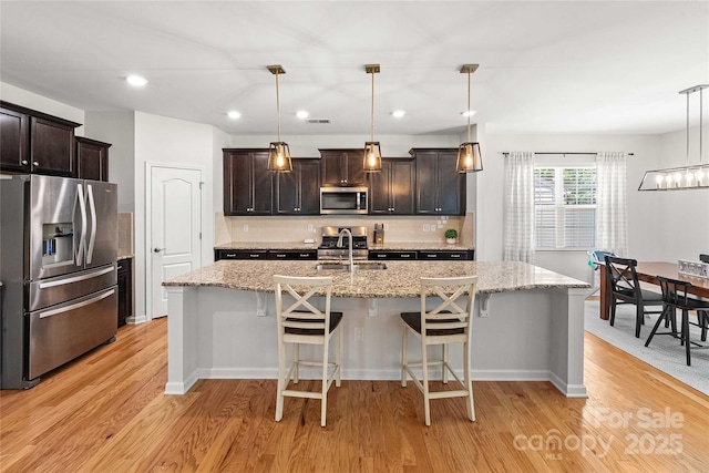 2333 Talon Point Cir, Fort Mill, SC 29715 - kitchen featuring stainless steel appliances, light wood-type flooring, tasteful backsplash, dark brown cabinetry, and recessed lighting
