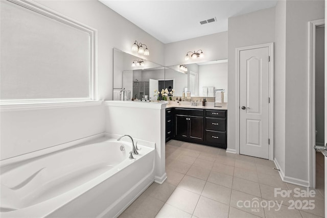 2333 Talon Point Cir, Fort Mill, SC 29715 - bathroom featuring tile patterned floors, a garden tub, vanity, and baseboards