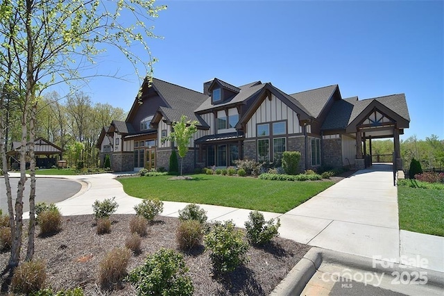 2333 Talon Point Cir, Fort Mill, SC 29715 - tudor-style house featuring board and batten siding, stone siding, a front yard, and a gazebo