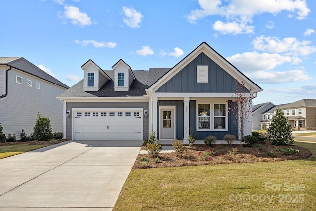 124 Canary Ln Unit 7, Mooresville, NC 28115 - view of front of home featuring board and batten siding, a garage, a front yard, driveway, and a porch