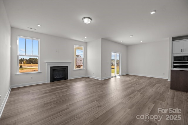 124 Canary Ln Unit 7, Mooresville, NC 28115 - unfurnished living room featuring a fireplace, recessed lighting, wood finished floors, and baseboards