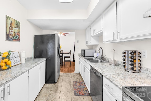 7407 Mystic Ln, Charlotte, NC 28227 - kitchen with a ceiling fan, stainless steel appliances, white cabinetry, and a sink