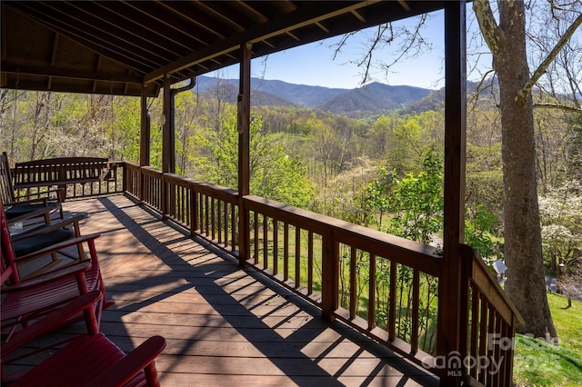 deck with a mountain view and a wooded view