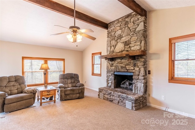 living area featuring ceiling fan, a stone fireplace, carpet flooring, and baseboards