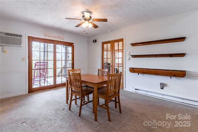 carpeted dining room with an AC wall unit, a baseboard heating unit, ceiling fan, a textured ceiling, and baseboards