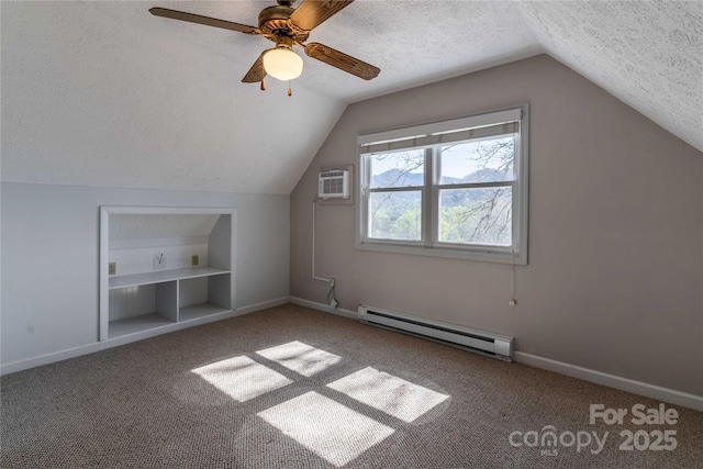 bonus room with a baseboard radiator, a textured ceiling, lofted ceiling, built in shelves, and carpet flooring