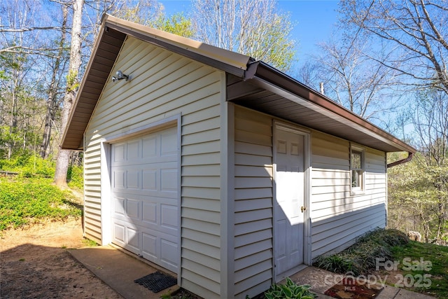 view of home's exterior featuring an outbuilding and a detached garage