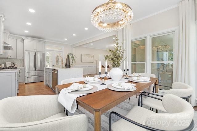 426 Walden Trl, Waxhaw, NC 28173 - dining area featuring recessed lighting, a notable chandelier, ornamental molding, and light wood-type flooring