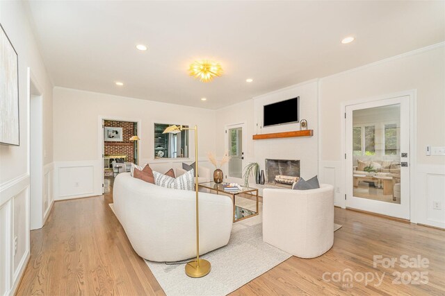 426 Walden Trl, Waxhaw, NC 28173 - living area with wood finished floors, a decorative wall, and a fireplace
