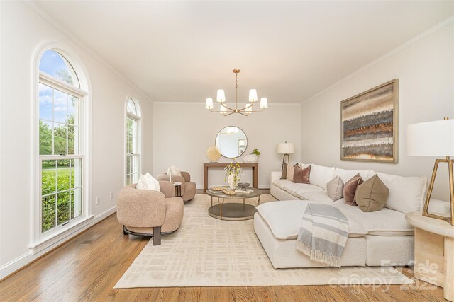 426 Walden Trl, Waxhaw, NC 28173 - living room with crown molding, baseboards, wood finished floors, and a chandelier