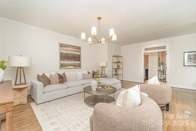 426 Walden Trl, Waxhaw, NC 28173 - living area with an inviting chandelier, baseboards, crown molding, and wood finished floors