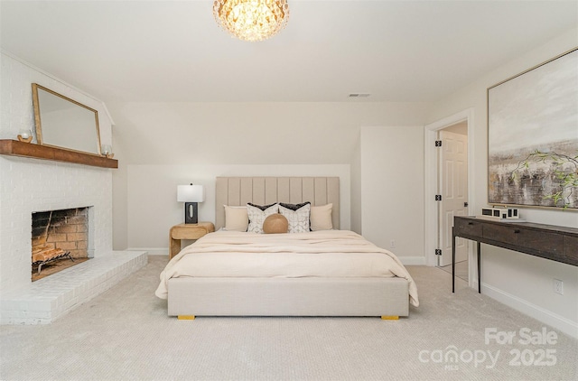 426 Walden Trl, Waxhaw, NC 28173 - bedroom with an inviting chandelier, light carpet, a brick fireplace, and visible vents