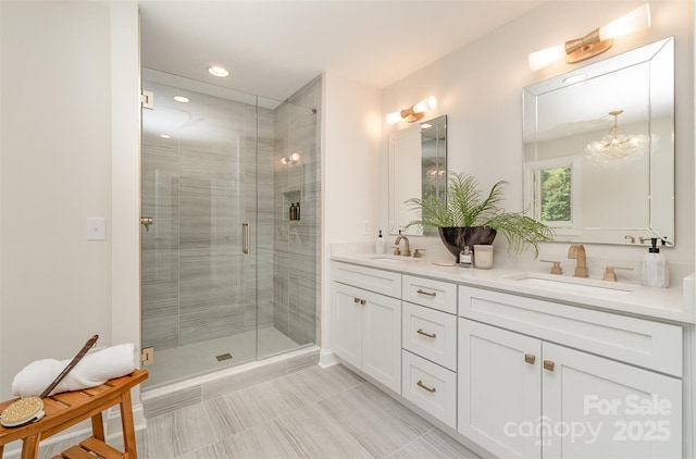 426 Walden Trl, Waxhaw, NC 28173 - full bath with double vanity, a notable chandelier, a shower stall, and a sink