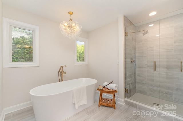 426 Walden Trl, Waxhaw, NC 28173 - full bath featuring baseboards, a freestanding bath, plenty of natural light, and a stall shower