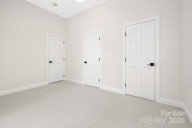 426 Walden Trl, Waxhaw, NC 28173 - unfurnished bedroom with baseboards and light carpet