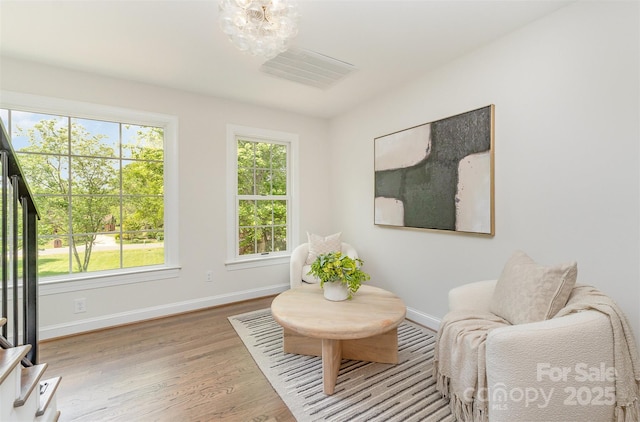 426 Walden Trl, Waxhaw, NC 28173 - sitting room featuring visible vents, wood finished floors, baseboards, a chandelier, and stairs