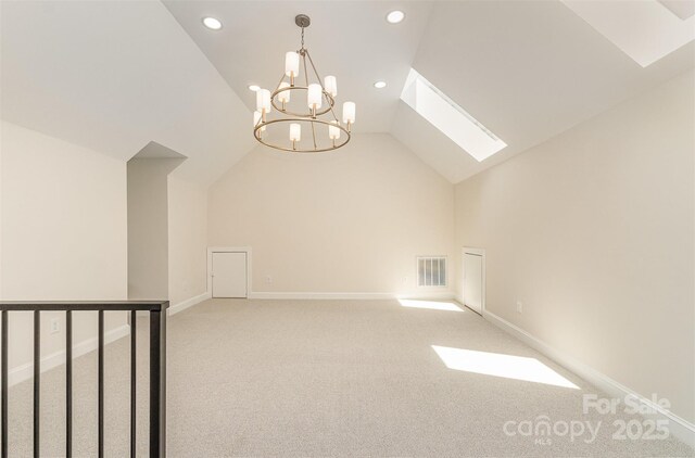 426 Walden Trl, Waxhaw, NC 28173 - additional living space with visible vents, an inviting chandelier, light carpet, lofted ceiling with skylight, and recessed lighting
