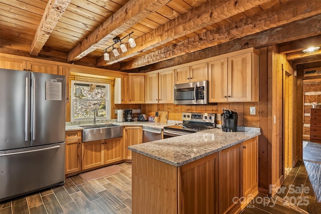 kitchen featuring beam ceiling, a sink, light stone counters, wooden ceiling, and appliances with stainless steel finishes