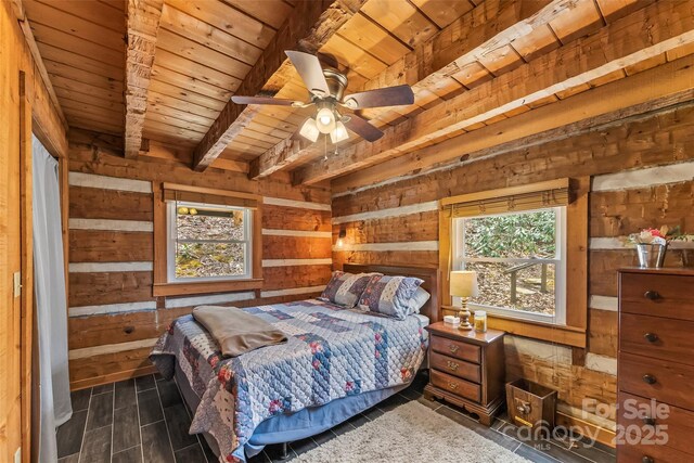 bedroom with wood ceiling, wood finished floors, wood walls, and beamed ceiling