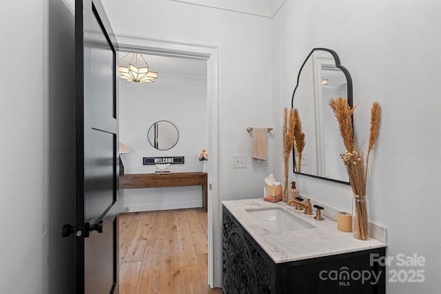 bathroom with hardwood / wood-style floors and vanity
