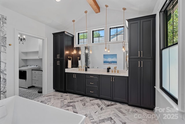 bathroom with marble finish floor, double vanity, a sink, washer / dryer, and lofted ceiling with beams