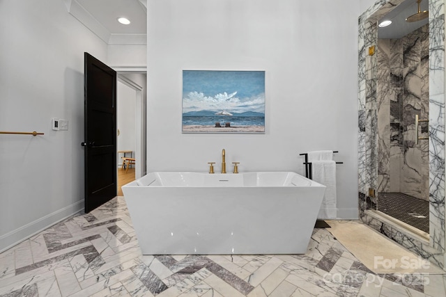 bathroom with marble finish floor, baseboards, a freestanding tub, and a marble finish shower