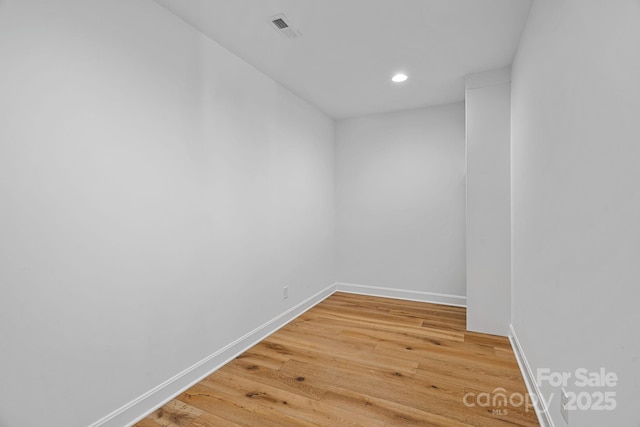 unfurnished room with recessed lighting, light wood-style floors, visible vents, and baseboards