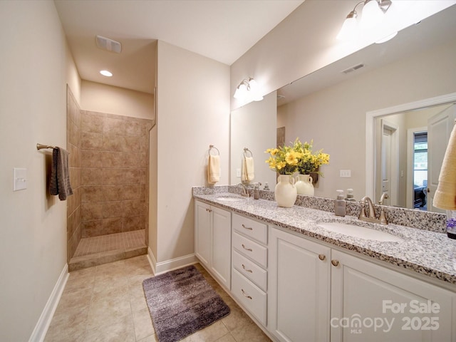 full bath with double vanity, visible vents, baseboards, and a sink