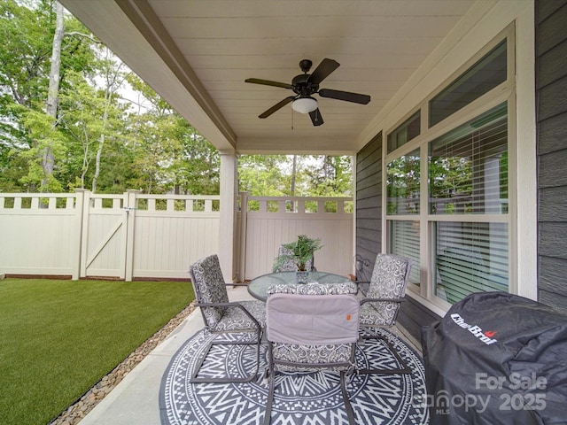 view of patio / terrace with a ceiling fan, outdoor dining space, area for grilling, and fence